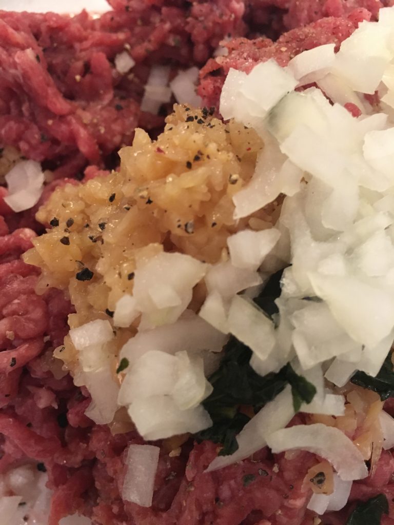Meatball ingredients - minced beef, egg, minced garlic, basil, oregano, onion, pepper and salt