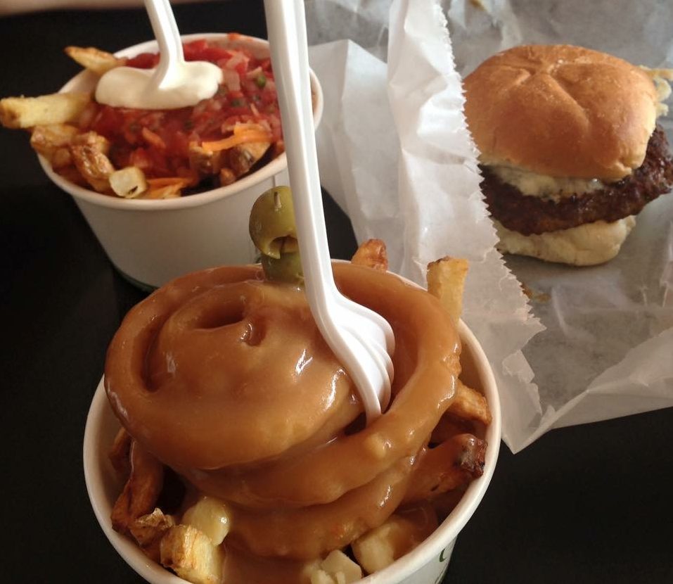 Poutine Martini (Crispy Fries & Onion Rings with White Cheese Curds & Gravy. Garnished with Olives.), Chili Fries (Fries with Shredded Cheddar, Chili & Sour Cream) and the A la Parisienne burger (With Brie, Grilled Onions & Dijon Mustard)
