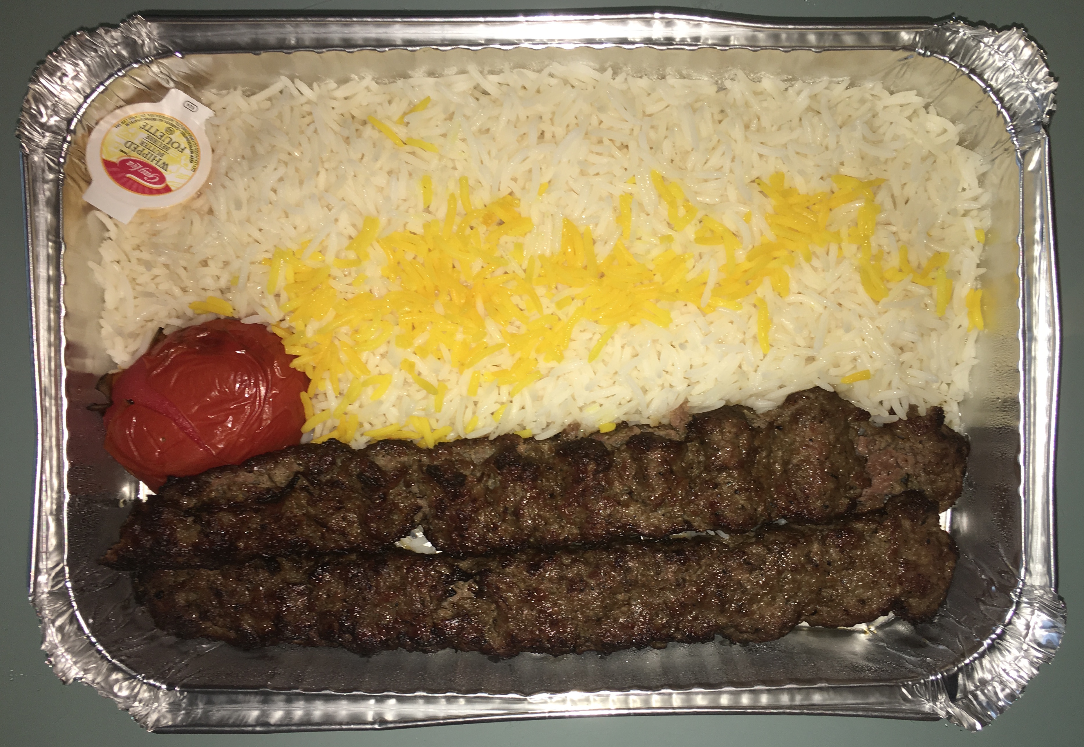 Koobideh Kebab - Two skewers of chef's lamb and beef special ground mix, basmati rice and grilled tomato