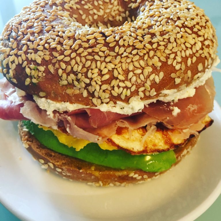 Pumpernickel Sesame Seed Bagel with Prosciutto, Fried Egg, Avocado and Whipped Cream Cheese and Chives