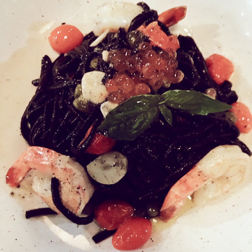 Nero pasta dish - squid-ink linguine, shrimp, sliced garlic, caper, basil leaf and salmon caviar
